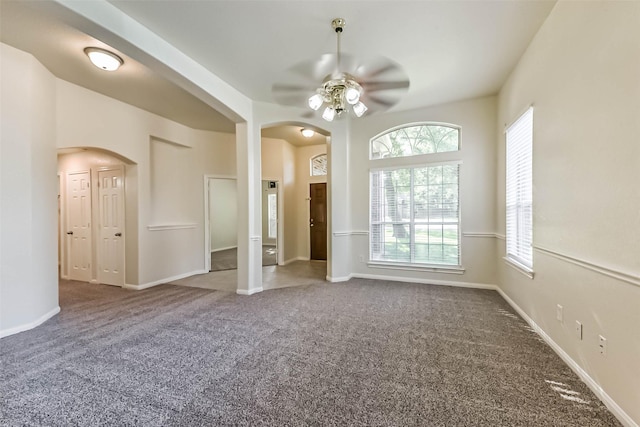 3506 Hickory Hill Ln, Montgomery, TX 77356 - spare room with arched walkways, carpet, ceiling fan, and healthy amount of natural light
