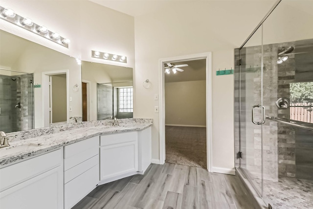 3506 Hickory Hill Ln, Montgomery, TX 77356 - bathroom featuring ceiling fan, wood finished floors, a stall shower, and double vanity