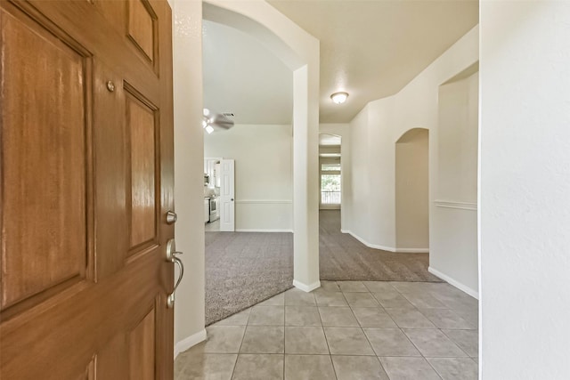 3506 Hickory Hill Ln, Montgomery, TX 77356 - entrance foyer with arched walkways, light carpet, light tile patterned flooring, and baseboards