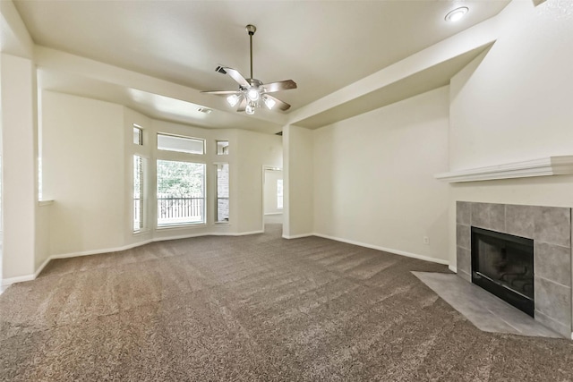 3506 Hickory Hill Ln, Montgomery, TX 77356 - unfurnished living room featuring carpet, a ceiling fan, a tile fireplace, and baseboards