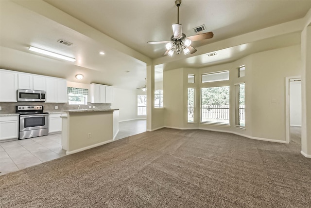 3506 Hickory Hill Ln, Montgomery, TX 77356 - kitchen with appliances with stainless steel finishes, light colored carpet, white cabinetry, tasteful backsplash, and open floor plan
