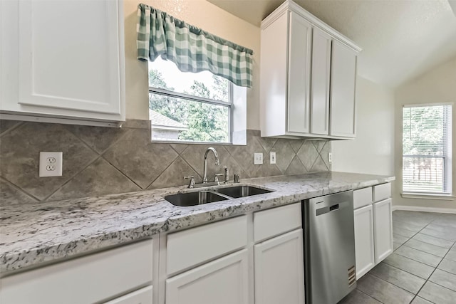 3506 Hickory Hill Ln, Montgomery, TX 77356 - kitchen with stainless steel dishwasher, a sink, tile patterned flooring, white cabinets, and backsplash
