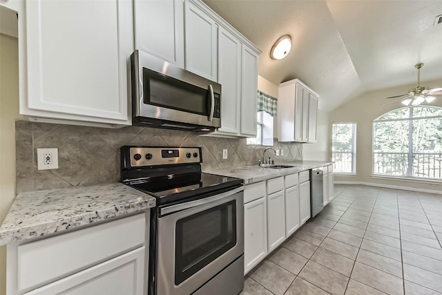3506 Hickory Hill Ln, Montgomery, TX 77356 - kitchen with appliances with stainless steel finishes, a sink, vaulted ceiling, tasteful backsplash, and white cabinets