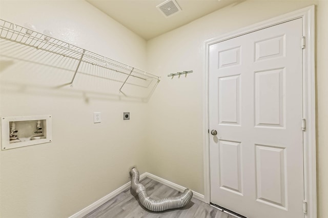 3506 Hickory Hill Ln, Montgomery, TX 77356 - washroom featuring hookup for an electric dryer, hookup for a washing machine, baseboards, and wood finished floors