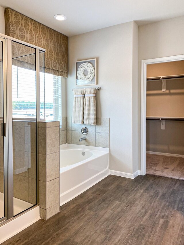2220 Manila Ln, Texas City, TX 77568 - full bath featuring a shower stall, a walk in closet, a bath, wood finished floors, and recessed lighting