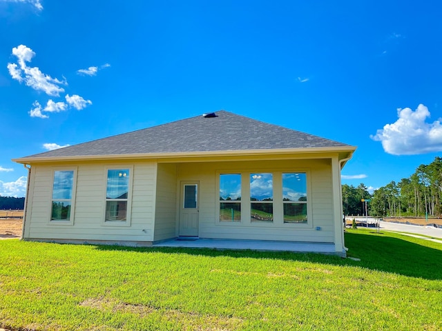 2220 Manila Ln, Texas City, TX 77568 - rear view of house featuring a yard, a patio, and a shingled roof