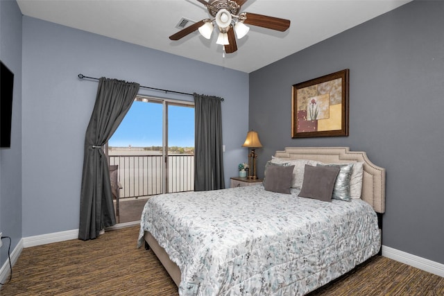 7039 Kingston Cove Ln Unit 309, Willis, TX 77318 - bedroom featuring dark carpet, access to exterior, baseboards, and ceiling fan