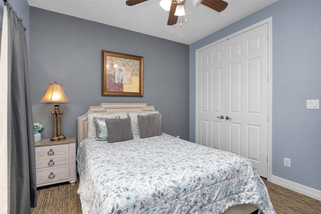 7039 Kingston Cove Ln Unit 309, Willis, TX 77318 - bedroom featuring baseboards, a closet, a ceiling fan, and dark wood finished floors