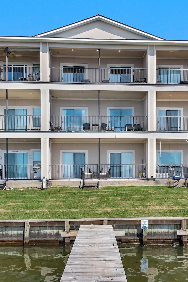 7039 Kingston Cove Ln Unit 309, Willis, TX 77318 - rear view of house featuring stucco siding and a water view