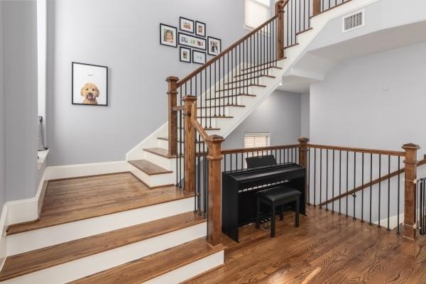 1042 W 23rd St Unit D, Houston, TX 77008 - staircase with wood finished floors, a high ceiling, and baseboards