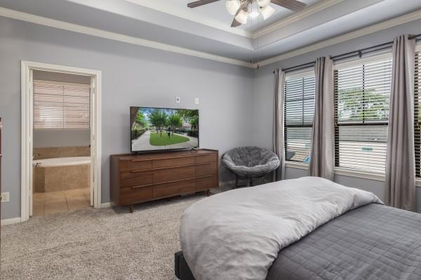 1042 W 23rd St Unit D, Houston, TX 77008 - carpeted bedroom with a raised ceiling, crown molding, ceiling fan, ensuite bathroom, and baseboards