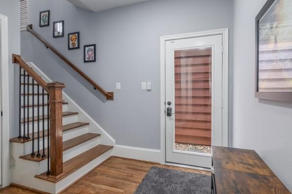 1042 W 23rd St Unit D, Houston, TX 77008 - foyer with wood finished floors, stairs, and baseboards