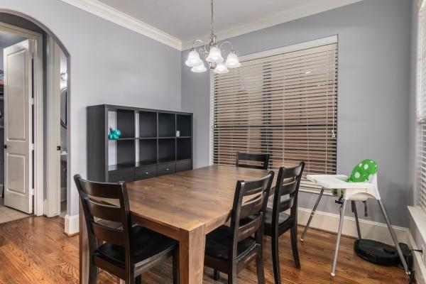 1042 W 23rd St Unit D, Houston, TX 77008 - dining area with ornamental molding, a chandelier, wood finished floors, and arched walkways