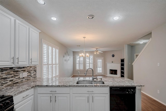 2710 Marigny Dr, Houston, TX 77014 - kitchen featuring black appliances, a sink, white cabinetry, decorative backsplash, and light stone countertops