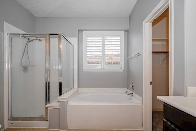 2710 Marigny Dr, Houston, TX 77014 - full bath with a shower stall, a garden tub, vanity, and a walk in closet