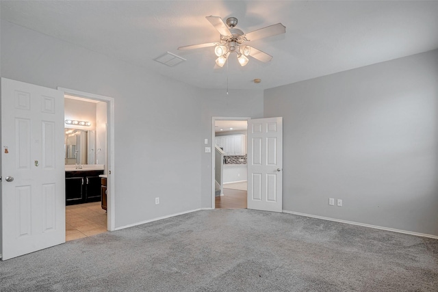 2710 Marigny Dr, Houston, TX 77014 - unfurnished bedroom with light colored carpet, baseboards, ensuite bathroom, and a ceiling fan