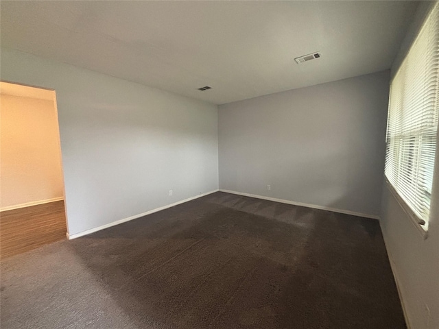 6210 Annunciation St, Houston, TX 77016 - unfurnished room with dark colored carpet and baseboards