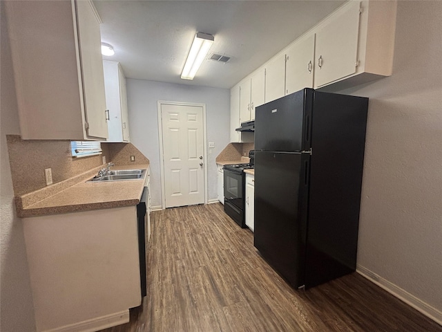 6210 Annunciation St, Houston, TX 77016 - kitchen with black appliances, dark wood-type flooring, white cabinets, backsplash, and a sink