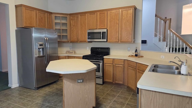 11143 Dawn Harvest Dr, Houston, TX 77064 - kitchen with appliances with stainless steel finishes, a sink, a center island, light countertops, and glass insert cabinets