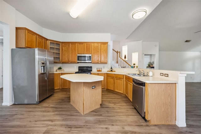 11143 Dawn Harvest Dr, Houston, TX 77064 - kitchen with appliances with stainless steel finishes, light countertops, a peninsula, and light wood-style flooring