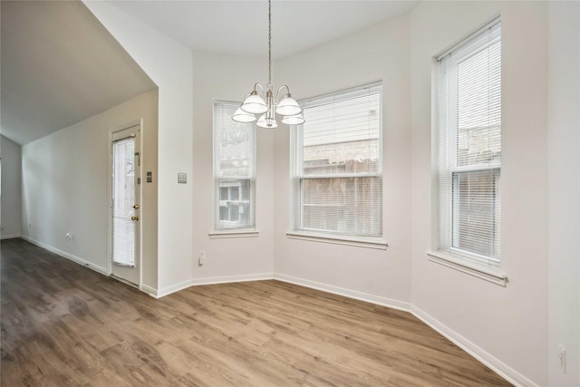 11143 Dawn Harvest Dr, Houston, TX 77064 - unfurnished dining area with a chandelier and wood finished floors
