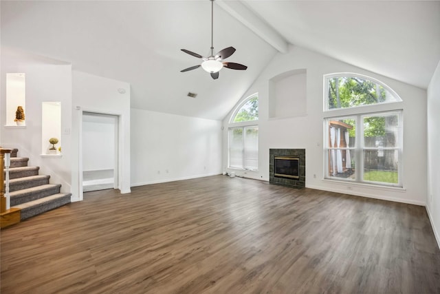 11143 Dawn Harvest Dr, Houston, TX 77064 - unfurnished living room featuring a ceiling fan, high vaulted ceiling, beamed ceiling, dark wood-type flooring, and a fireplace