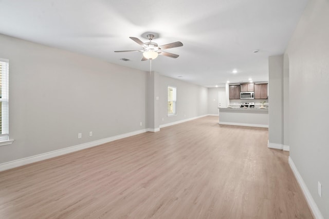 6230 El Cobre Dr, Houston, TX 77048 - unfurnished living room with light wood-type flooring, ceiling fan, baseboards, and recessed lighting