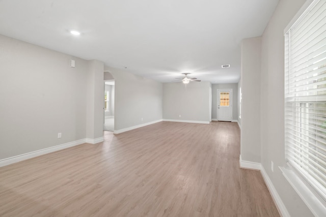 6230 El Cobre Dr, Houston, TX 77048 - spare room with arched walkways, a ceiling fan, light wood-style floors, and baseboards