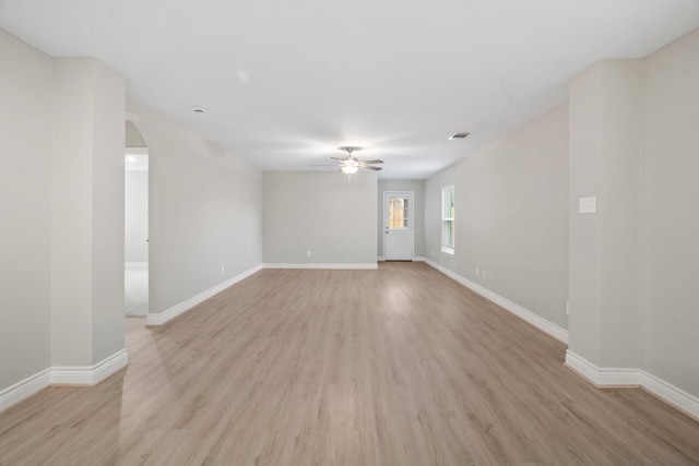 6230 El Cobre Dr, Houston, TX 77048 - spare room featuring ceiling fan, light wood-style floors, arched walkways, and baseboards