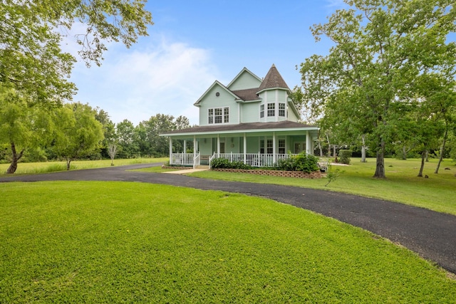 2350 Hawk Mdws, Pearland, TX 77581 - victorian-style house featuring covered porch, a front yard, asphalt driveway, and roof with shingles