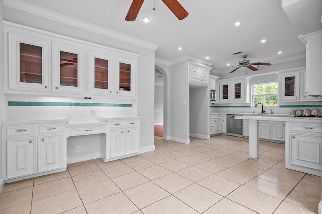 2350 Hawk Mdws, Pearland, TX 77581 - kitchen featuring a ceiling fan, stainless steel appliances, white cabinetry, light countertops, and arched walkways