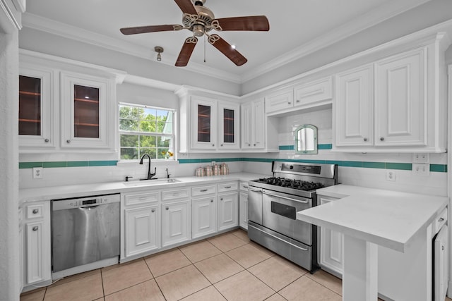 2350 Hawk Mdws, Pearland, TX 77581 - kitchen with appliances with stainless steel finishes, a sink, white cabinetry, light tile patterned floors, and light countertops