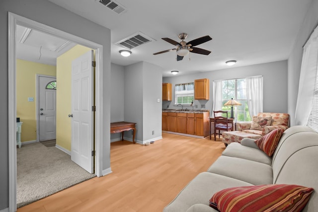 2350 Hawk Mdws, Pearland, TX 77581 - living room featuring attic access, a ceiling fan, baseboards, and light wood-style floors