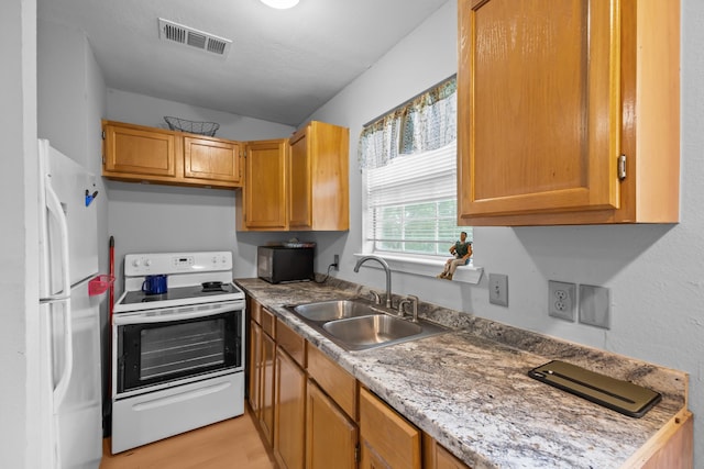 2350 Hawk Mdws, Pearland, TX 77581 - kitchen featuring white appliances, a sink, light wood-style floors, and light countertops