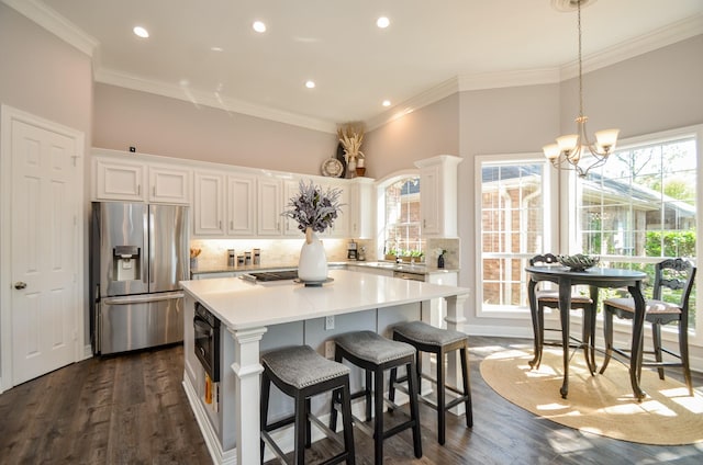 7 Champion Villa Dr, Houston, TX 77069 - kitchen featuring appliances with stainless steel finishes, white cabinetry, a kitchen island, tasteful backsplash, and recessed lighting