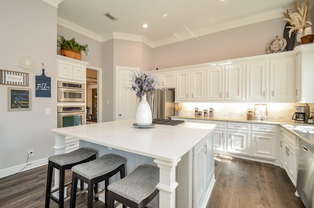 7 Champion Villa Dr, Houston, TX 77069 - kitchen featuring appliances with stainless steel finishes, white cabinets, backsplash, dark wood-style flooring, and crown molding