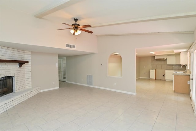 5502 Irish Hill Dr, Houston, TX 77053 - unfurnished living room featuring a ceiling fan, a fireplace, baseboards, a sink, and high vaulted ceiling