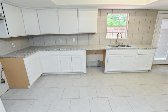 5502 Irish Hill Dr, Houston, TX 77053 - kitchen featuring a sink, decorative backsplash, and white cabinets