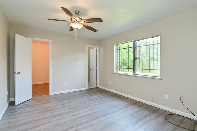 5502 Irish Hill Dr, Houston, TX 77053 - unfurnished bedroom featuring wood finished floors, baseboards, and a ceiling fan
