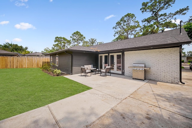 5630 Lymbar Dr, Houston, TX 77096 - back of property featuring french doors, a patio, roof with shingles, and brick siding