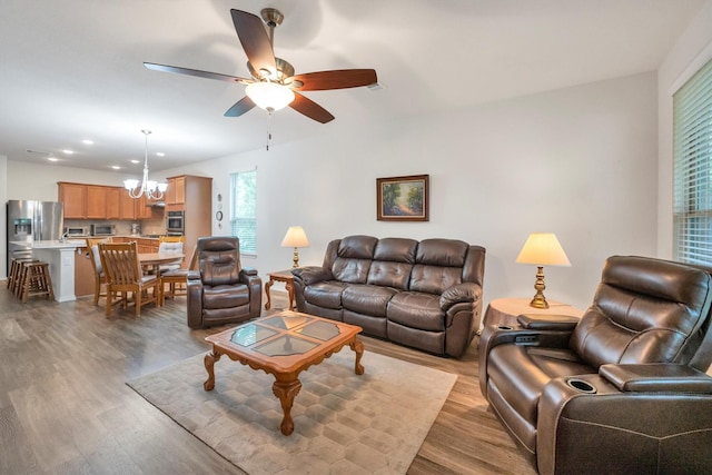 2114 Lost Timbers Dr, Conroe, TX 77304 - living room featuring light wood-style flooring, a chandelier, ceiling fan, and recessed lighting