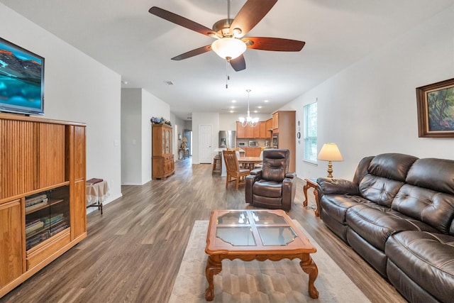 2114 Lost Timbers Dr, Conroe, TX 77304 - living room with wood finished floors, a ceiling fan, and a chandelier