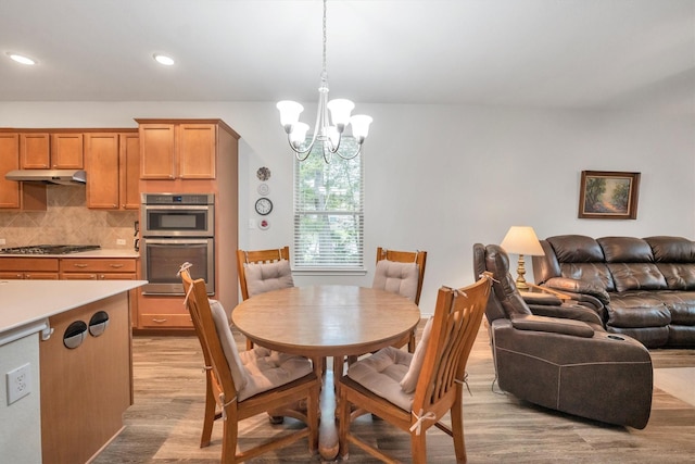2114 Lost Timbers Dr, Conroe, TX 77304 - dining space featuring light wood-style flooring, a chandelier, and recessed lighting