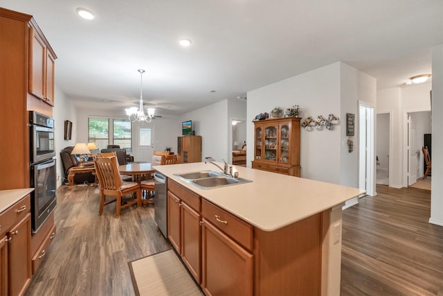 2114 Lost Timbers Dr, Conroe, TX 77304 - kitchen with a sink, a chandelier, stainless steel appliances, brown cabinets, and recessed lighting