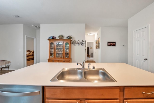 2114 Lost Timbers Dr, Conroe, TX 77304 - kitchen with a sink, light countertops, stainless steel dishwasher, and brown cabinets