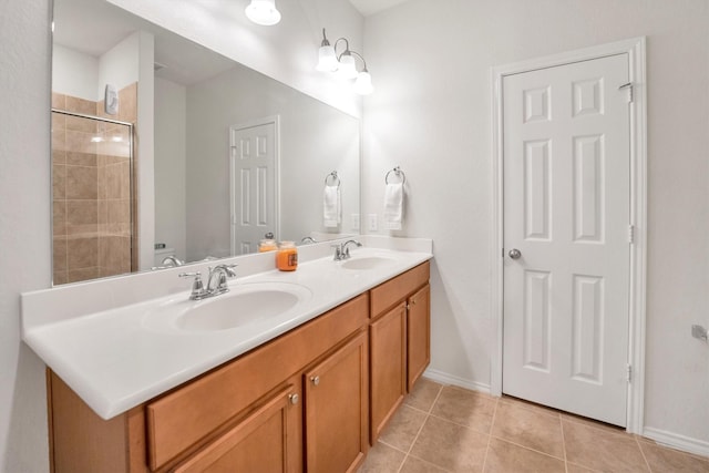 2114 Lost Timbers Dr, Conroe, TX 77304 - full bathroom featuring double vanity, tile patterned flooring, baseboards, and a tile shower