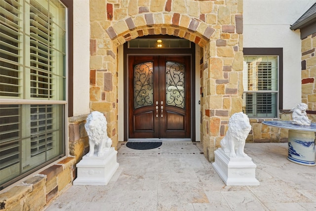 2915 Sentry Oak Way, Sugar Land, TX 77479 - view of exterior entry featuring stone siding and french doors