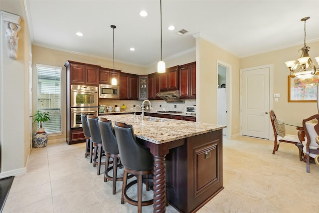 2915 Sentry Oak Way, Sugar Land, TX 77479 - kitchen featuring a sink, appliances with stainless steel finishes, tasteful backsplash, light stone countertops, and a kitchen breakfast bar
