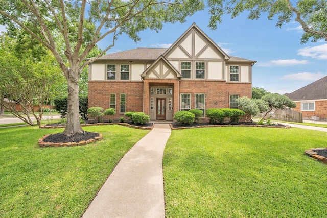 7318 Starbridge Dr, Houston, TX 77095 - english style home featuring stucco siding, brick siding, and a front yard