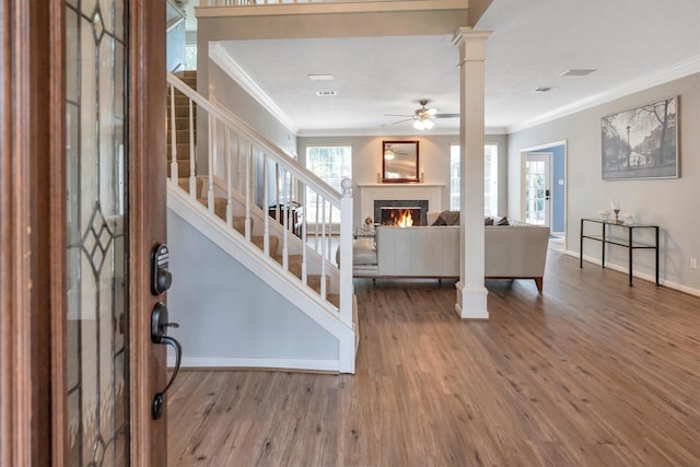 7318 Starbridge Dr, Houston, TX 77095 - entrance foyer featuring crown molding, a ceiling fan, stairway, wood finished floors, and decorative columns